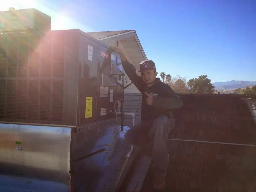 HVAC technician performing Boiler Repair on a rooftop unit in West Richland